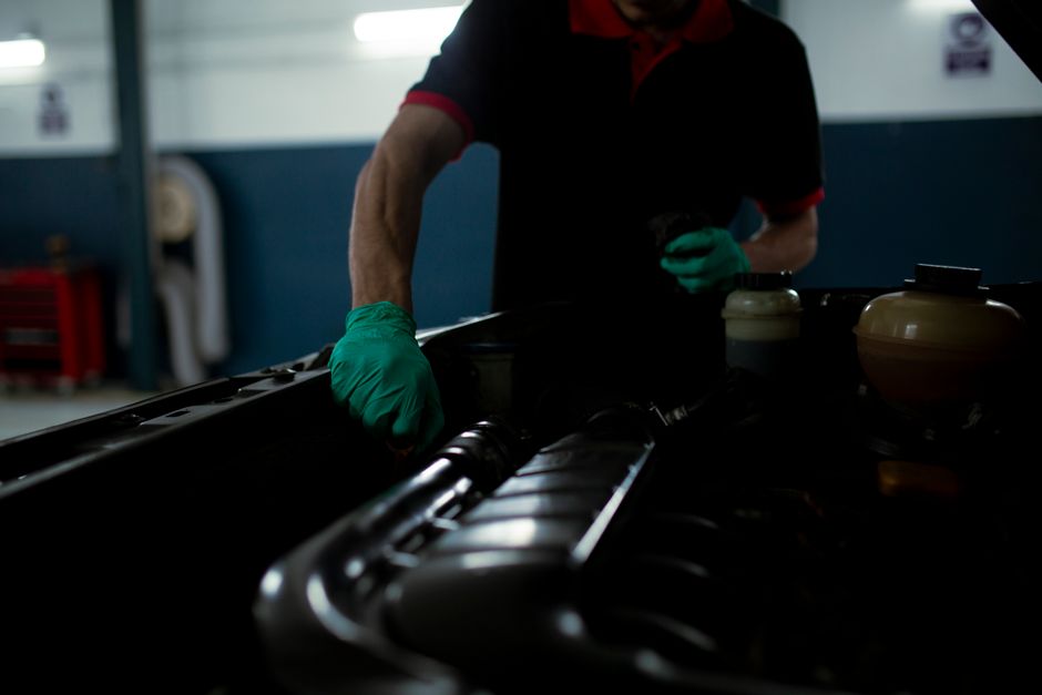 Professional hands holding pie chart data near laptop in modern office setting.
